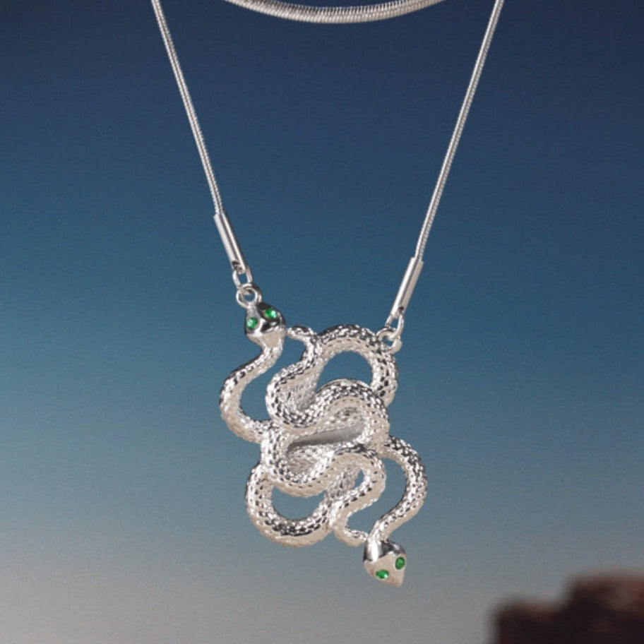 The serpent body flows smoothly in a custom steel tone,
bringing a refined, radiant shine.
Designed with a double-layer snake bone chain，
adding distinctive character to your styling.