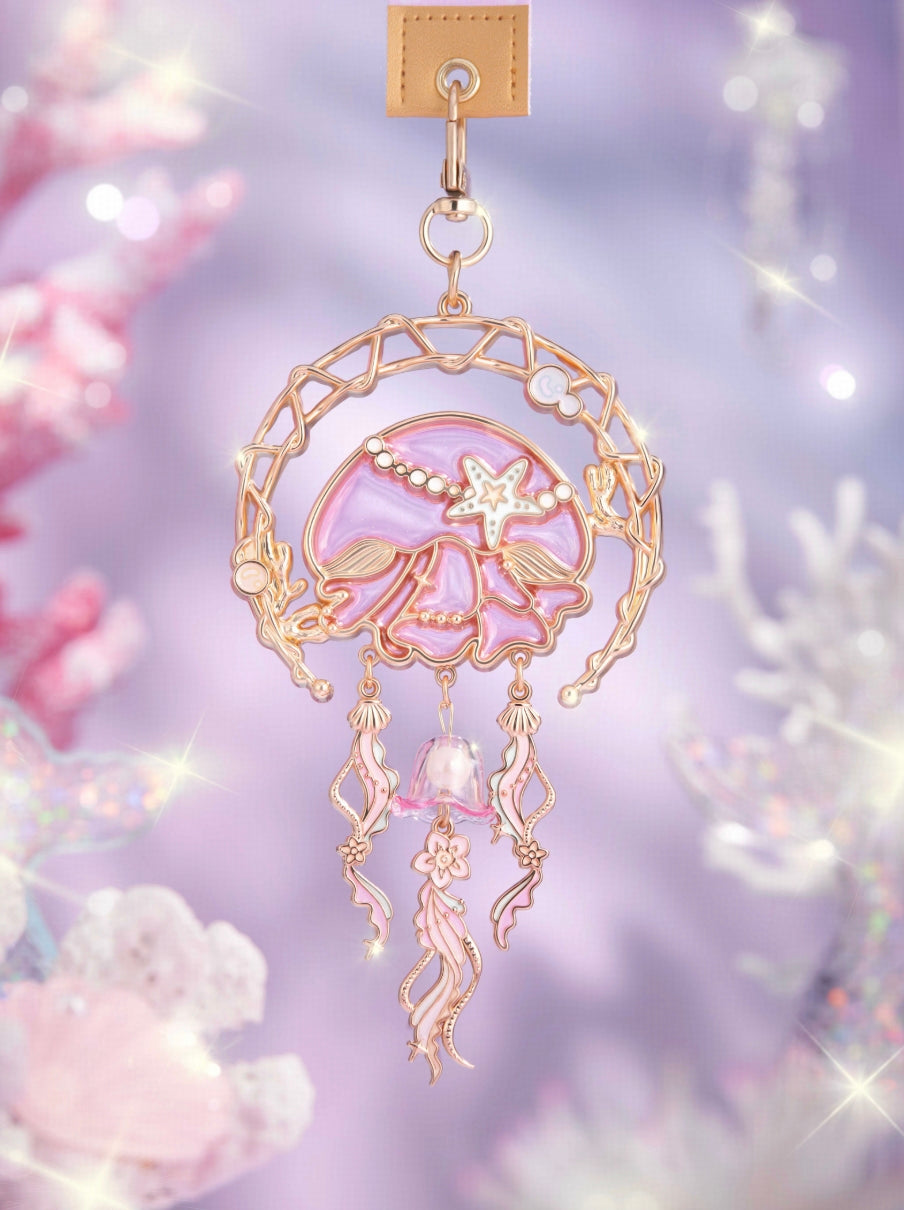 Crafted with semi-transparent glass enamel and embossed detailing,
the design outlines the “Ocean Dream” dreamcatcher motif.